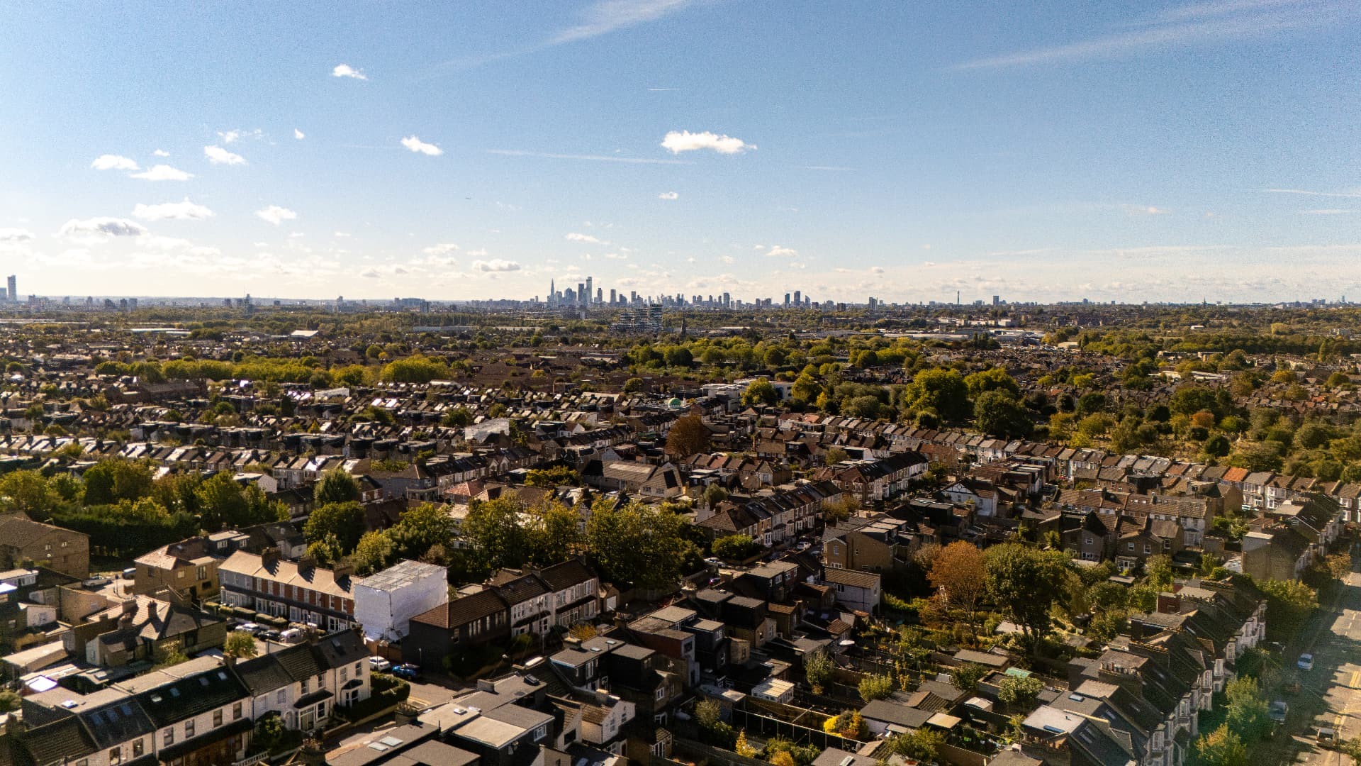 Aerial view over Walthamstow's rooftops towards the London skyline